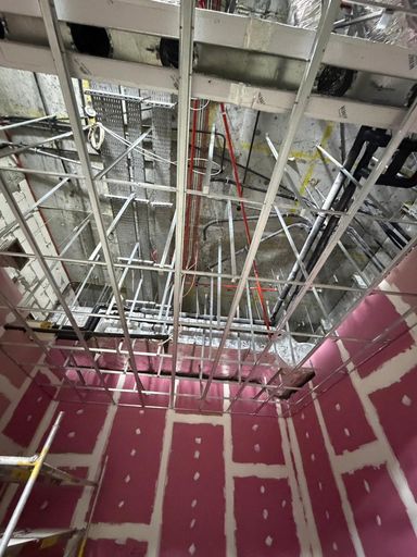 V CARE technician installing fire-rated gypsum partitions at Damac Paramount Hotel, Business Bay